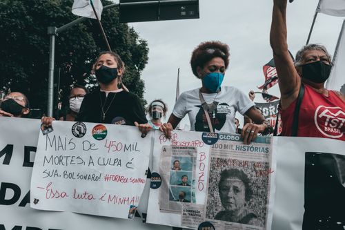 Free Protesters in Rio de Janeiro rally against government policies holding signs. Stock Photo