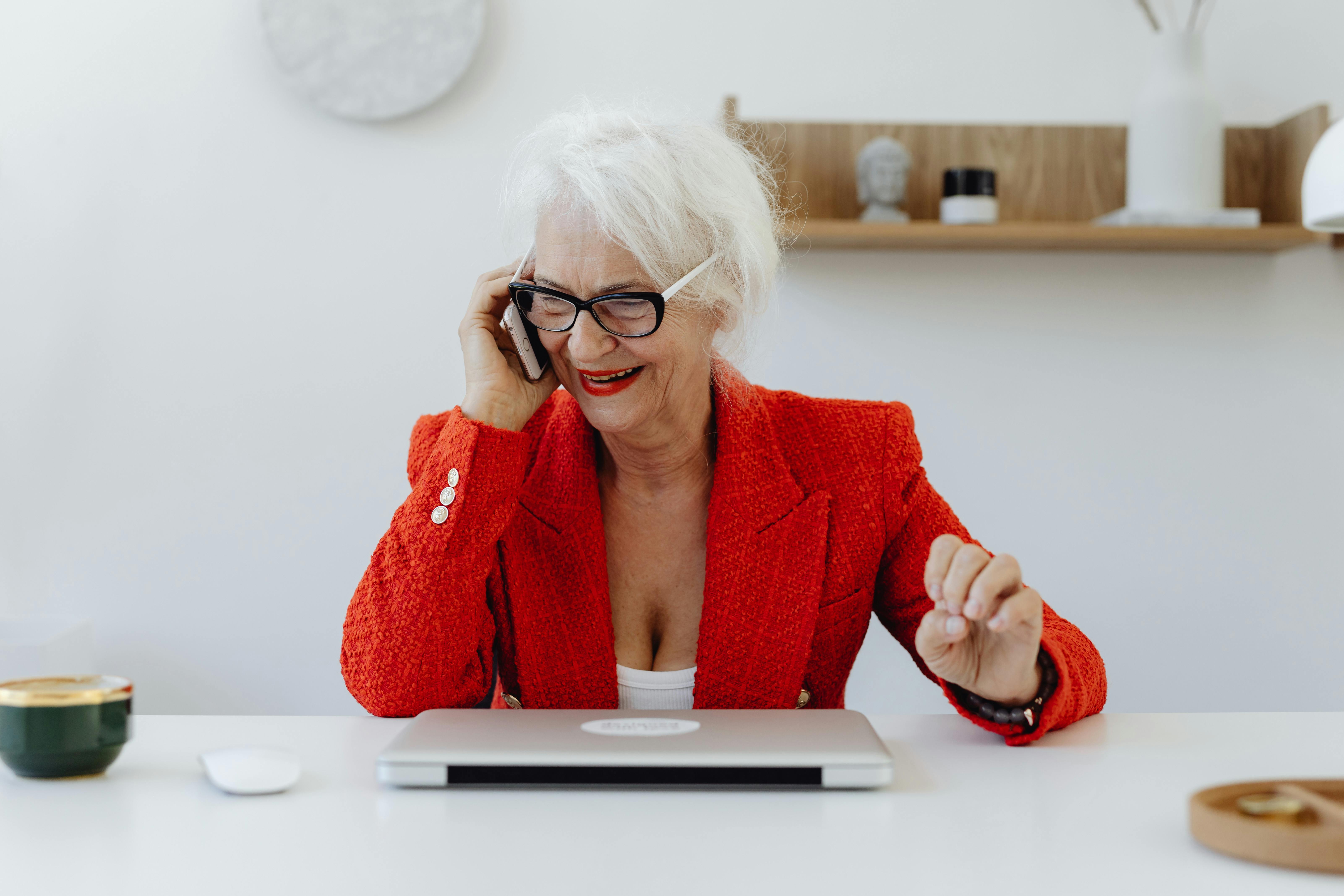 a woman in red blazer talking on her cellphone