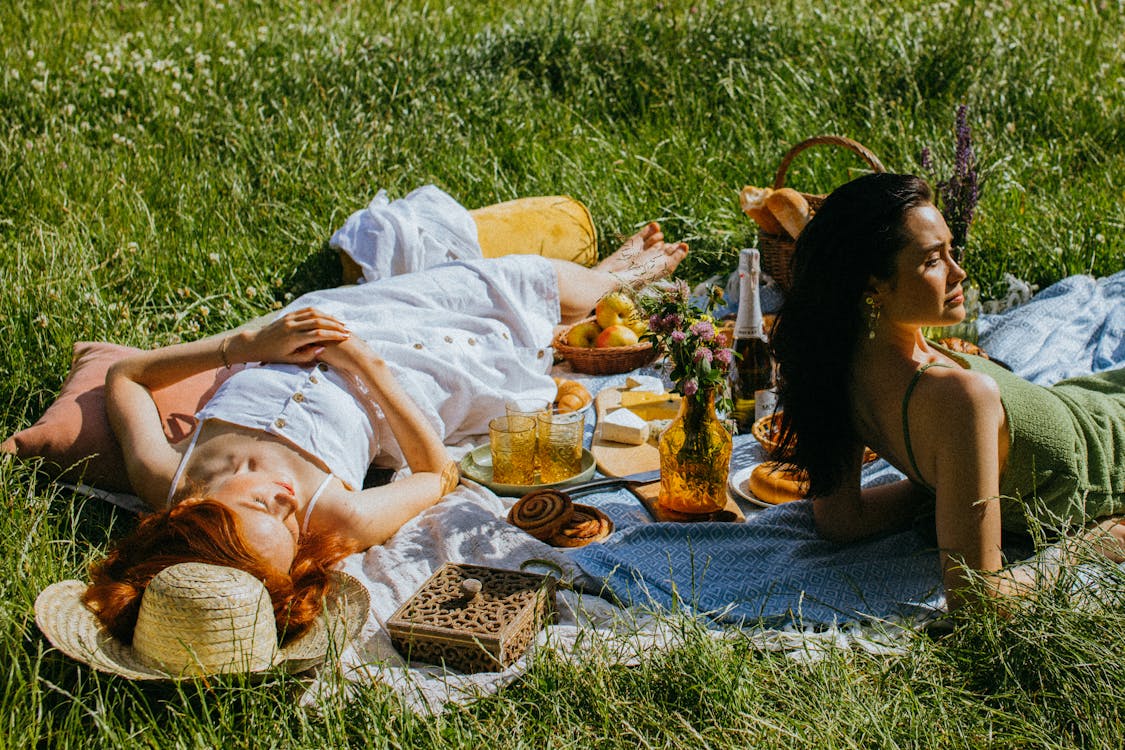 Women Lying Down Leisurely on the Picnic Blanket