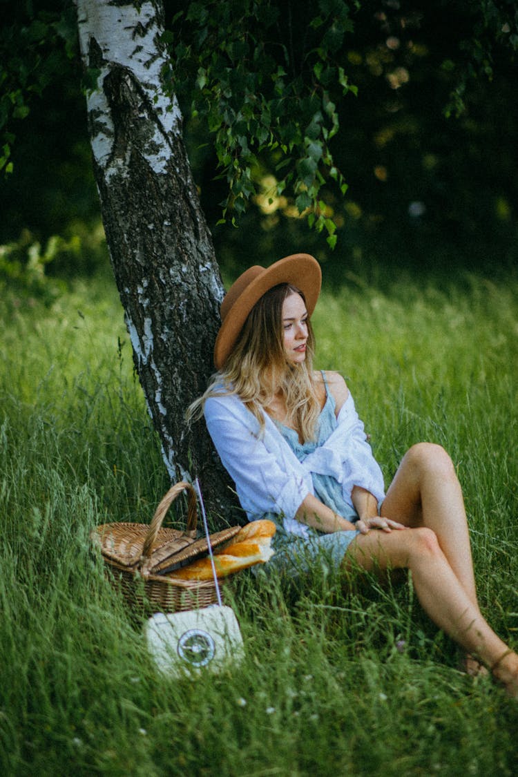 A Woman Sitting On Grass