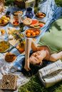 Woman Lying on Picnic Blanket
