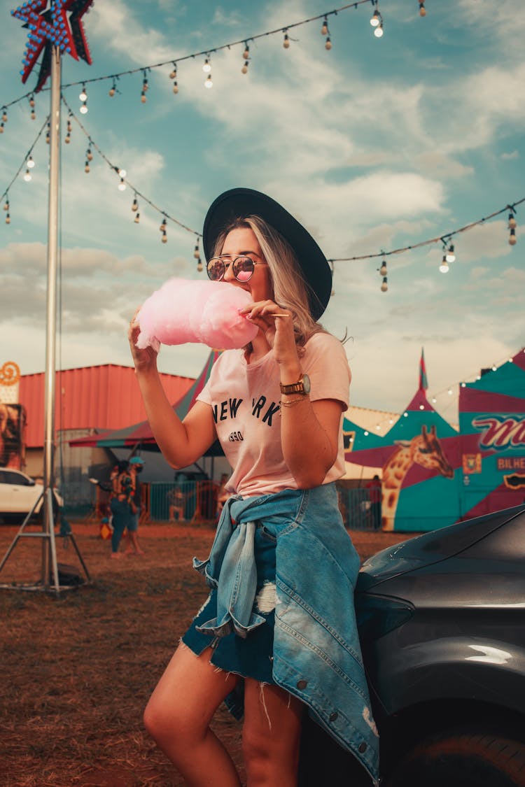 Woman Eating Cotton Candy At Fair