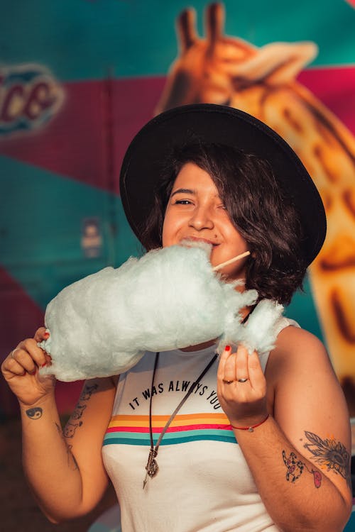 Smiling Woman Eating Cotton Candy 
