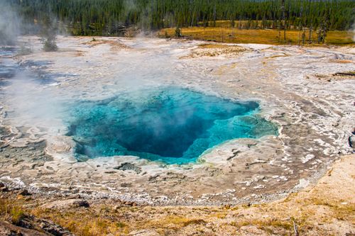 Free Stunning view of a vibrant hot spring with steam in Yellowstone National Park, Wyoming. Stock Photo