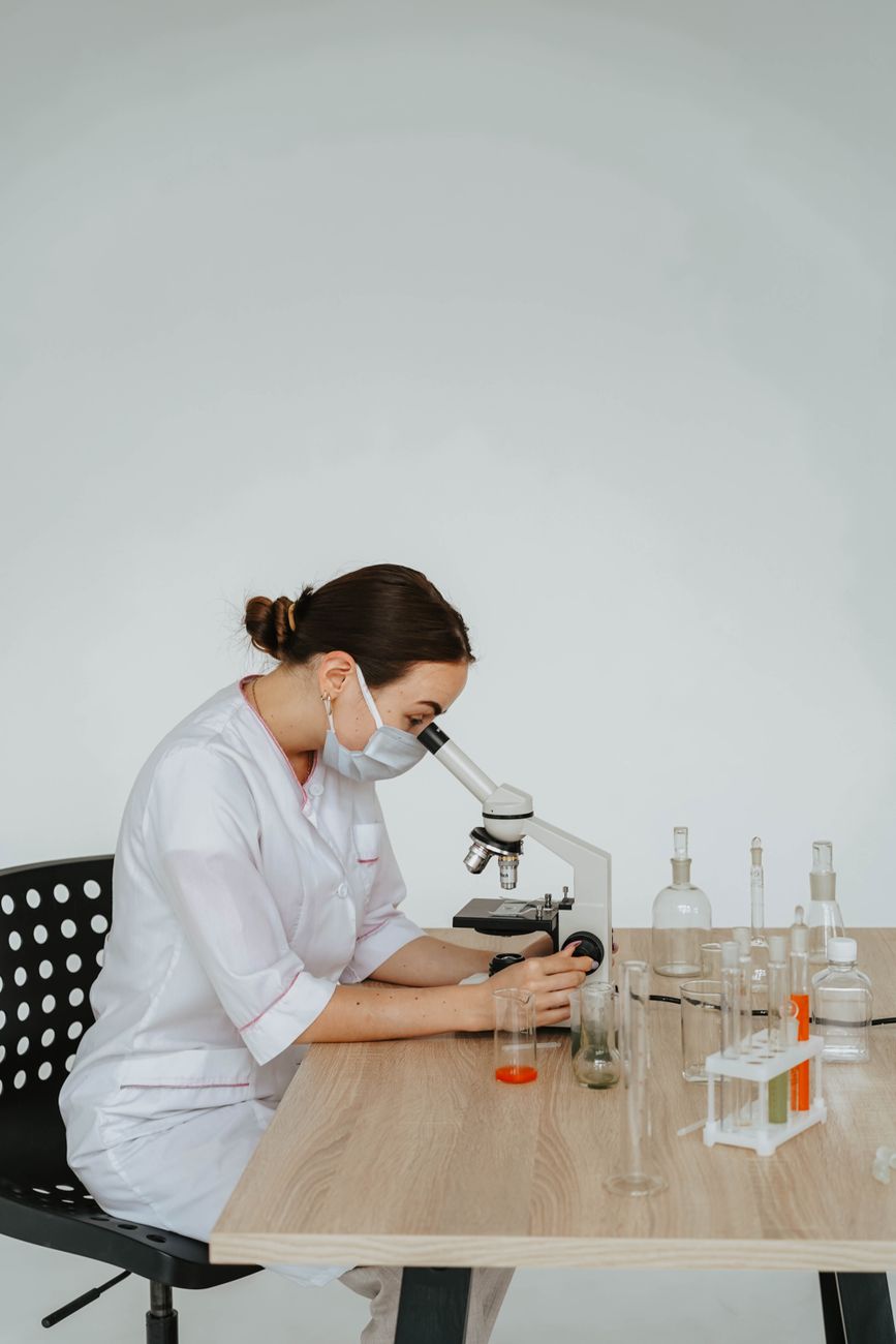 Researchers at work in a modern laboratory, representing the multiyear studies and graduate programs now in limbo due to funding cuts.