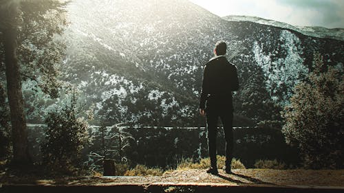 Free Man Standing On Cliff Stock Photo