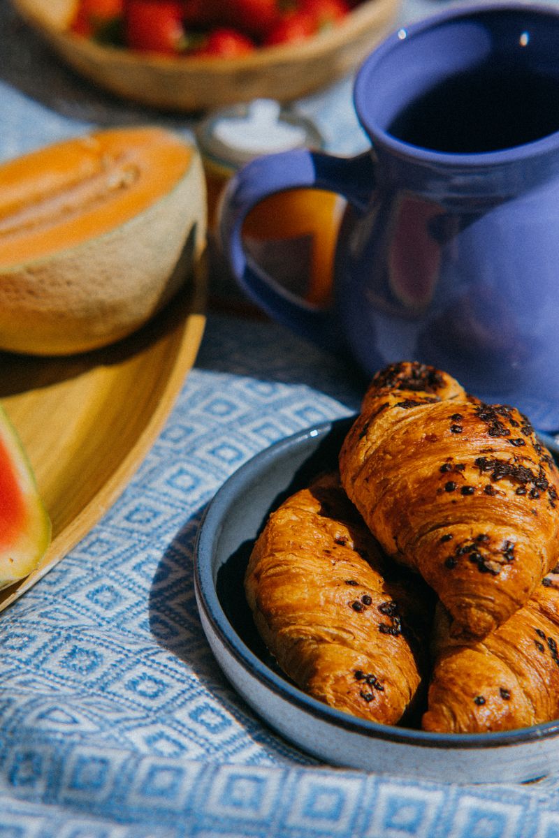 Fresh croissants and fruit on a breakfast spread