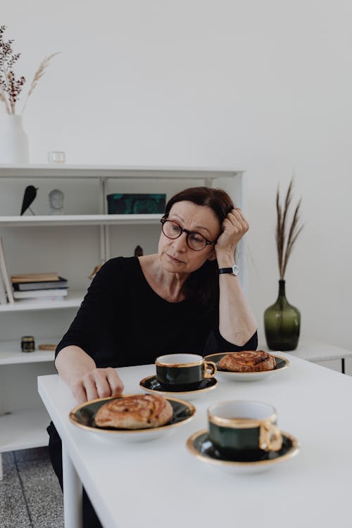 A Sad Woman in Black Top Sitting