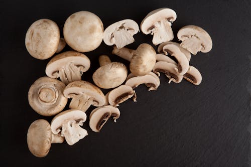 Close-Up Shot of Fresh Mushrooms on a Black Surface