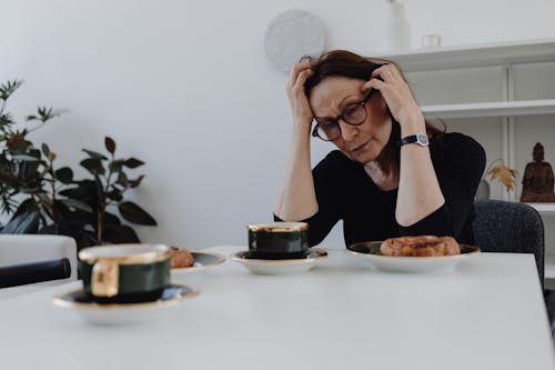 A Sad Woman in Black Top Sitting