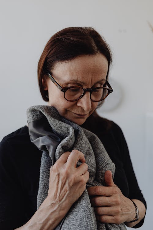 A Sad Woman in Black Top Holding a Gray Cloth