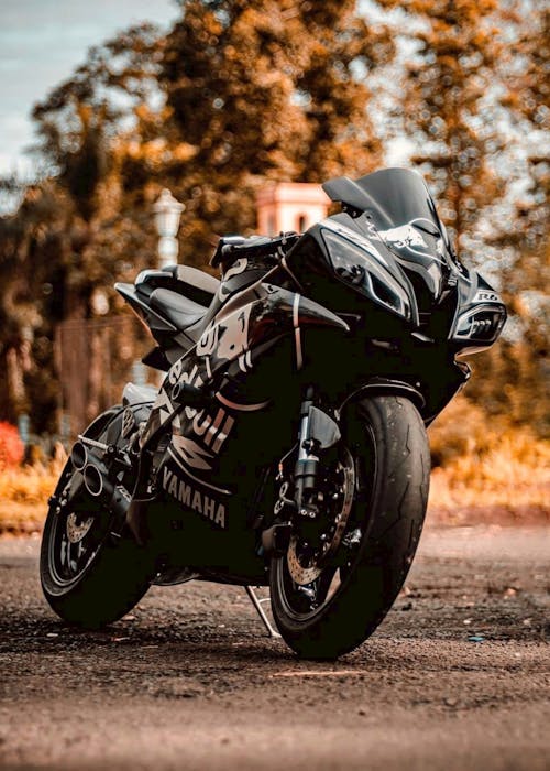 A Black Sports Bike Parked on the Road