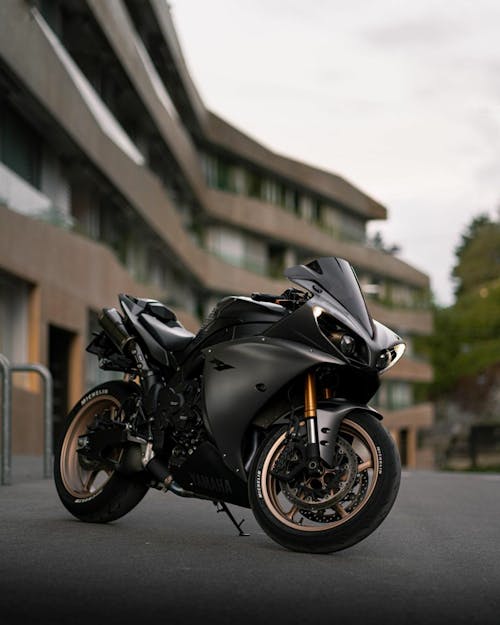 A Black Sports Bike Parked on the Road