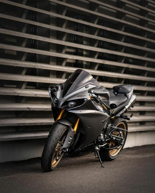 Free A Black Sports Bike Parked on the Street Stock Photo
