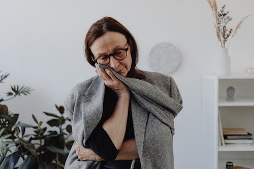 A Sad Woman in Black Top Holding a Gray Cloth