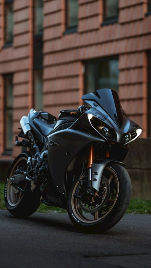 Free A Black Sports Bike Parked on the Street Stock Photo