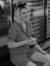 Woman in Stripe Shirt Holding Cup