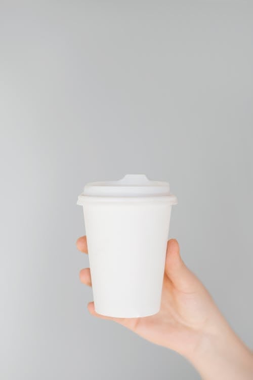 Person Holding White Disposable Cup