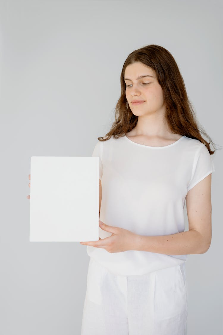 Woman In White Outfit Holding A Blank Paper