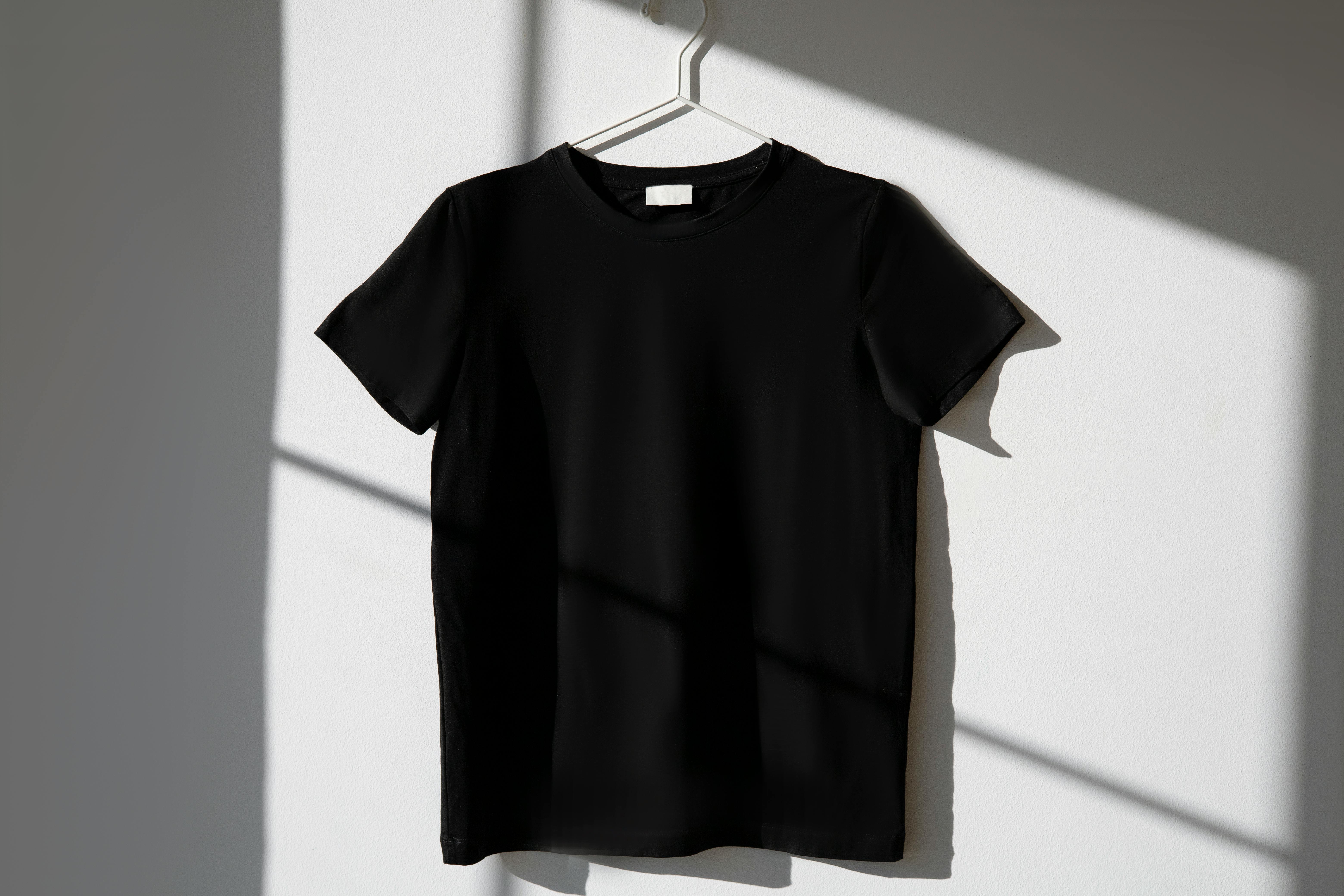 A Black Shirt Hanging on the Wall · Free Stock Photo