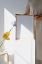 Woman in White Wedding Dress Holding White Frame