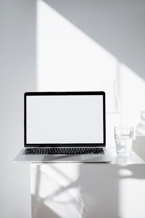 Free Macbook Mockup on White Table Stock Photo