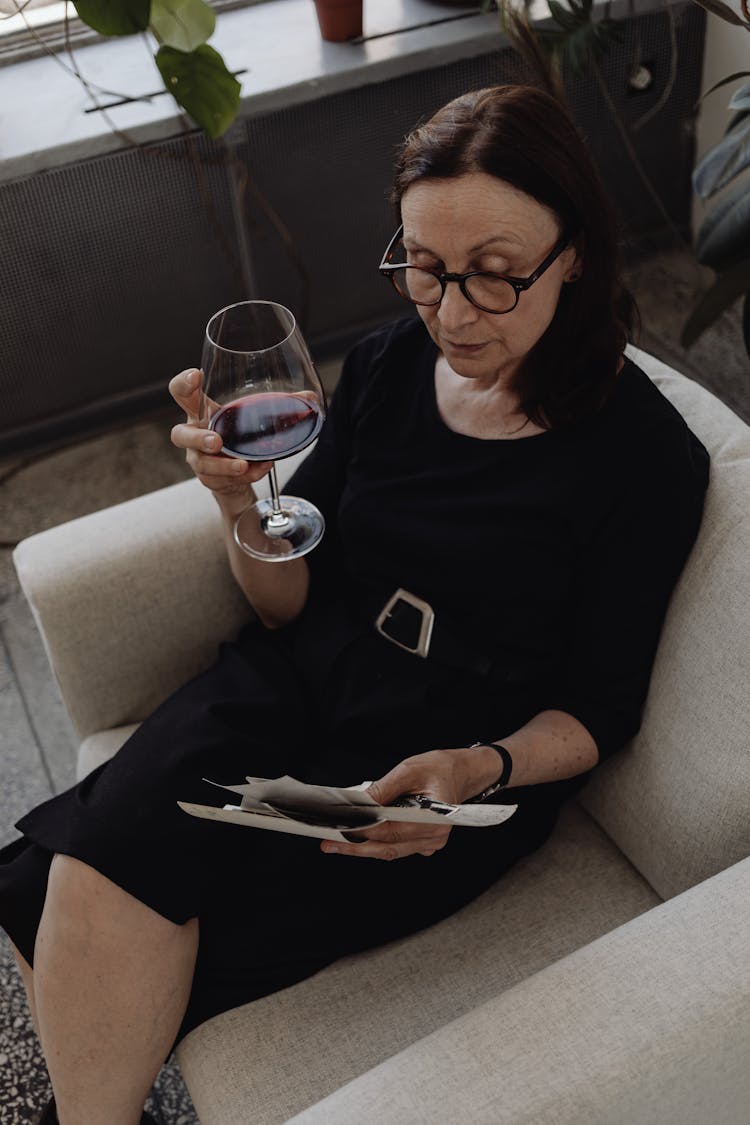 An Elderly Woman Looking At Pictures