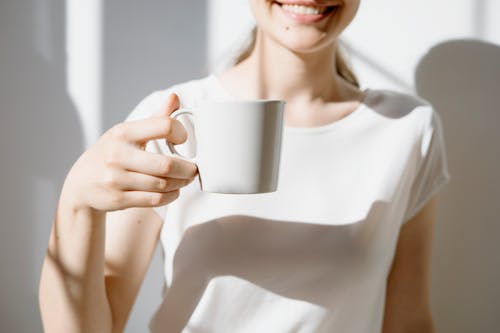 Free Woman Holding a Mug of Coffee Stock Photo