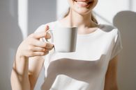 Woman Holding a Mug of Coffee