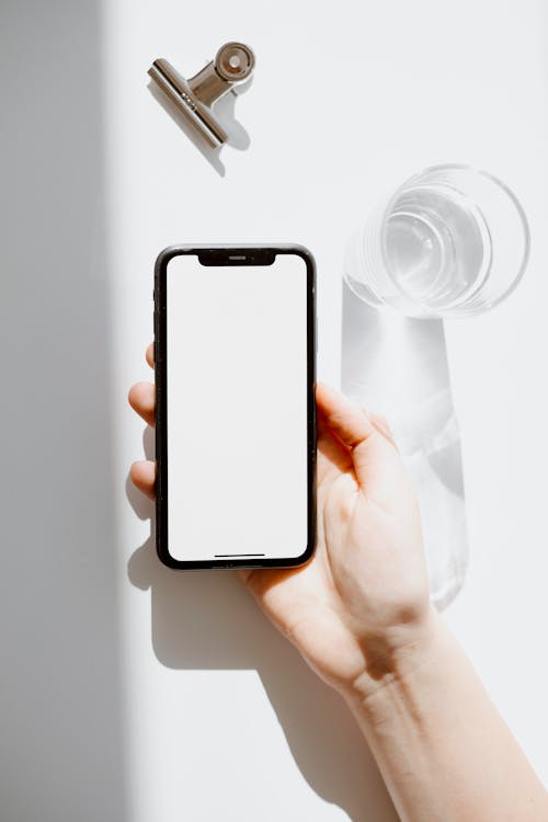 Free Smartphone Near Glass of Water Stock Photo