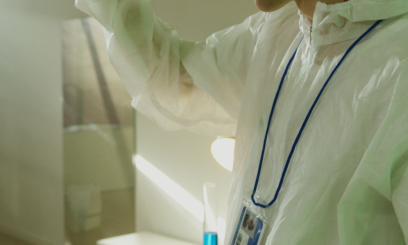 Chemist examining a laboratory sample in a glass tube