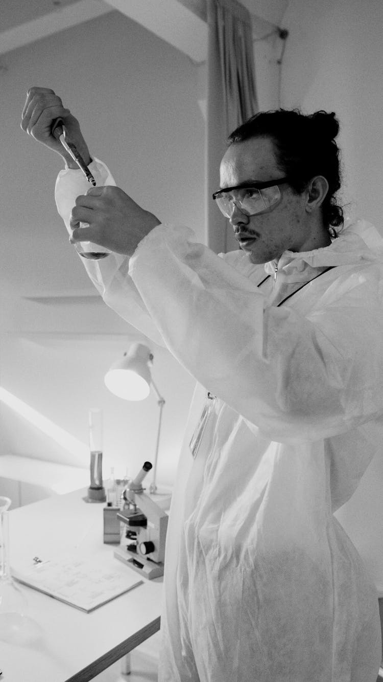 Grayscale Photo Of A Scientist Doing Research Work Of Chemicals