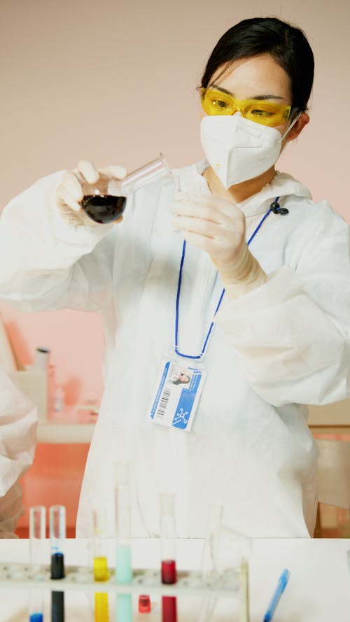 Young Chemist Experimenting Chemicals Pouring on Test Tube