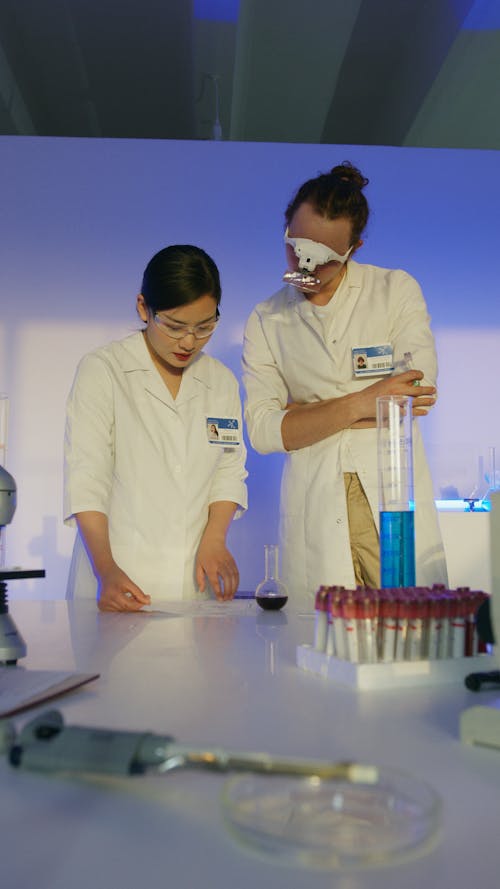 Medical Professionals Discussing on a Table Results on Paper Inside a Science Laboratory