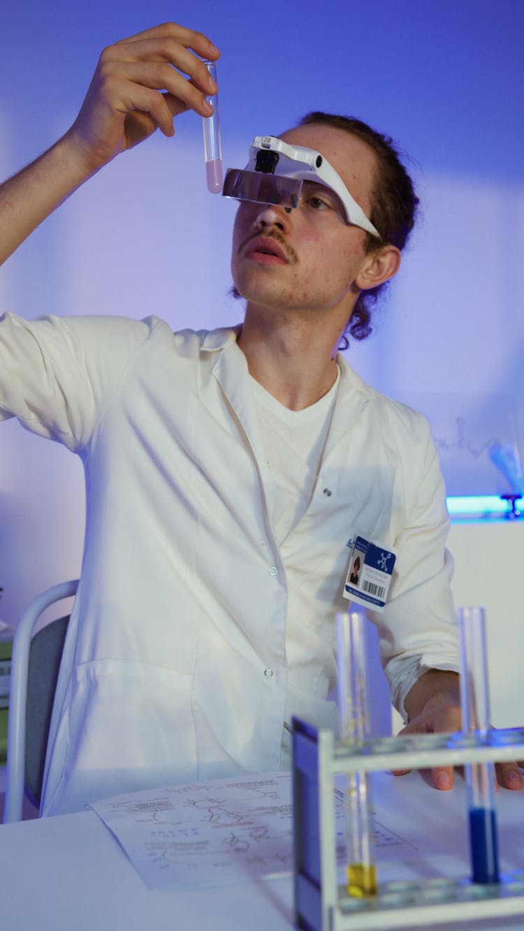 Man Holding A Test Tube In Science Laboratory