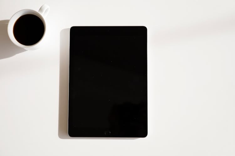 Close-Up Shot Of A Black Ipad On White Surface