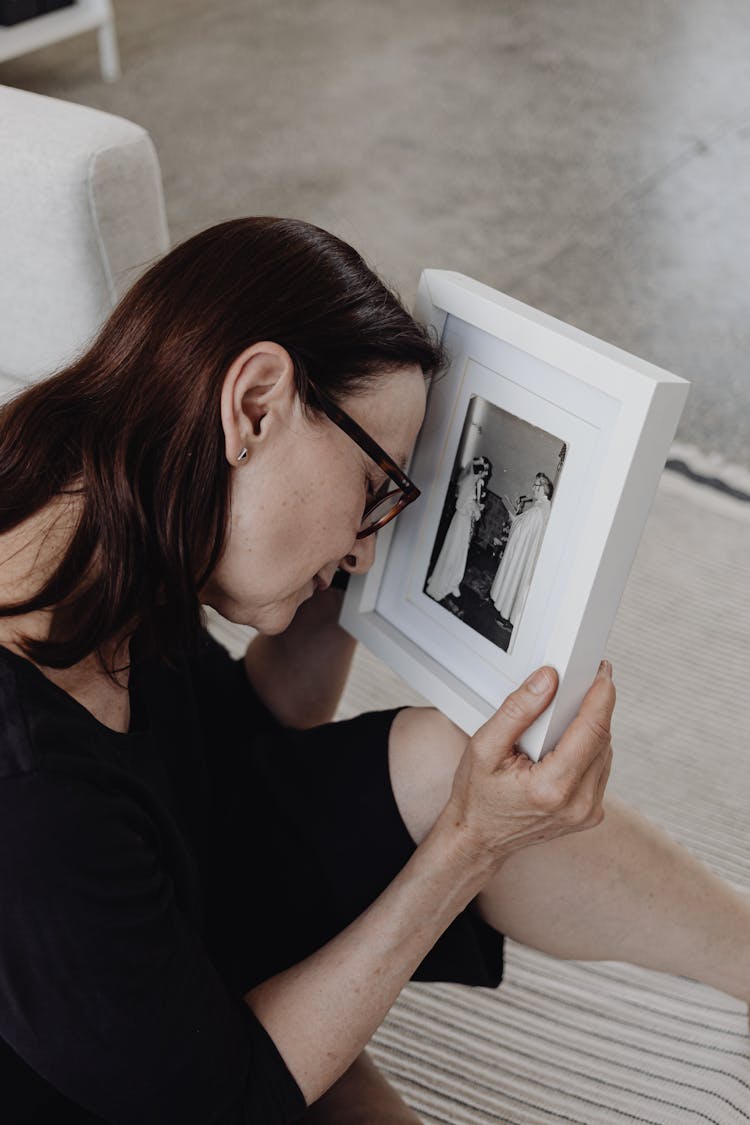 Woman With Old Wedding Photograph