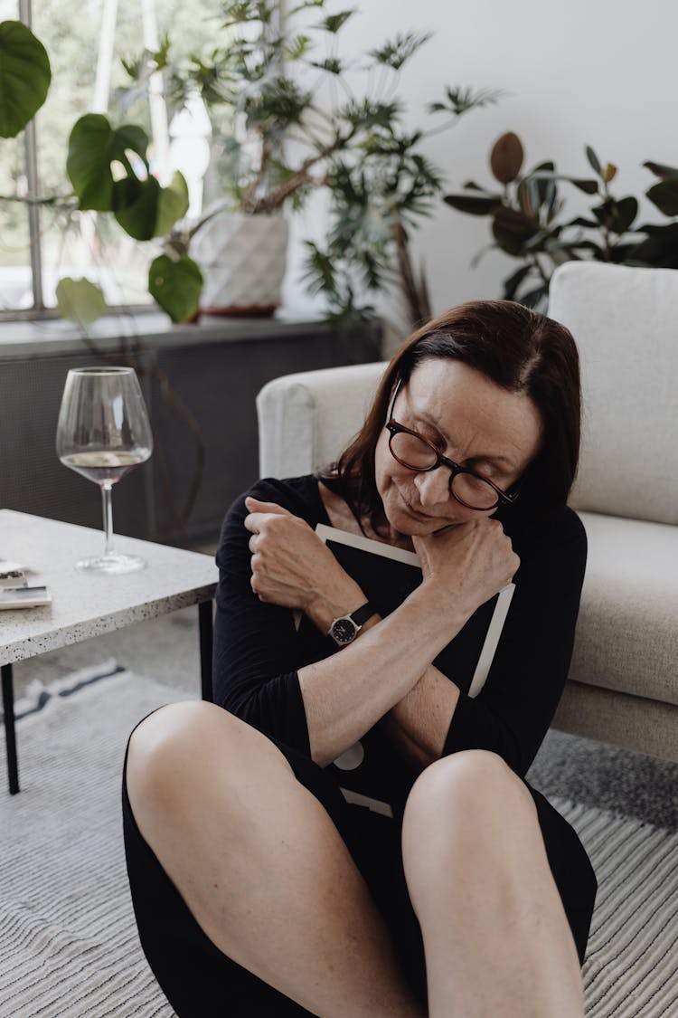 Woman Embracing A Picture Frame