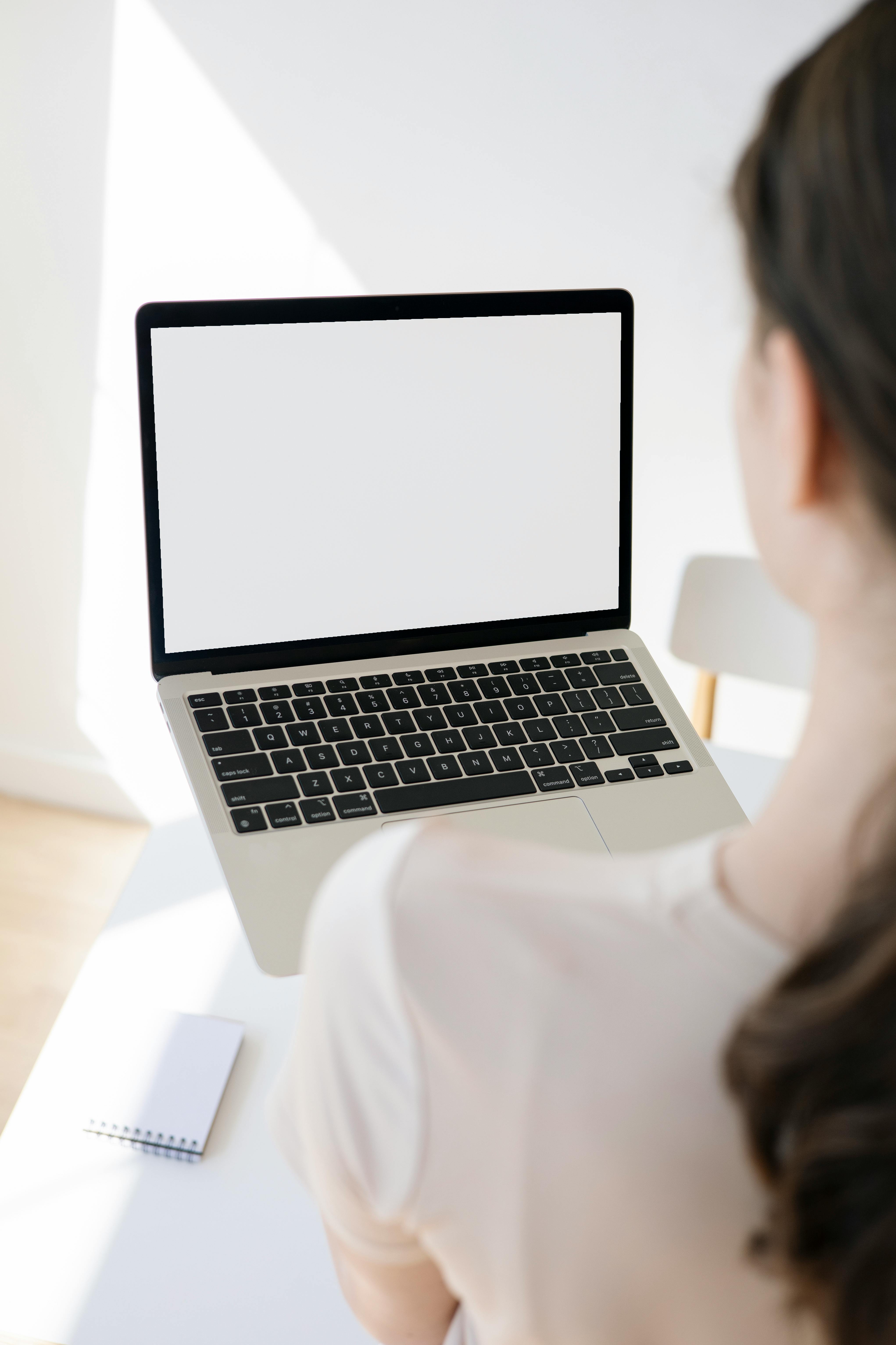 person in white shirt and a laptop