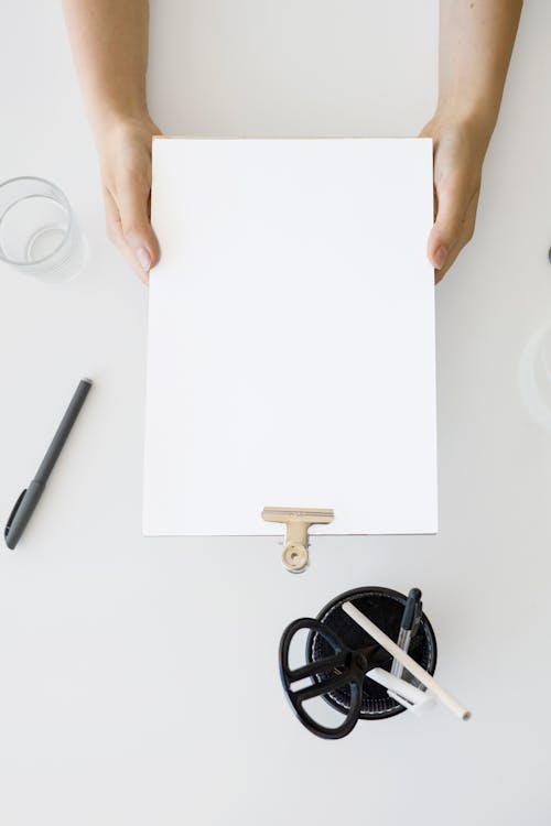 A Person Holding White Printer Paper