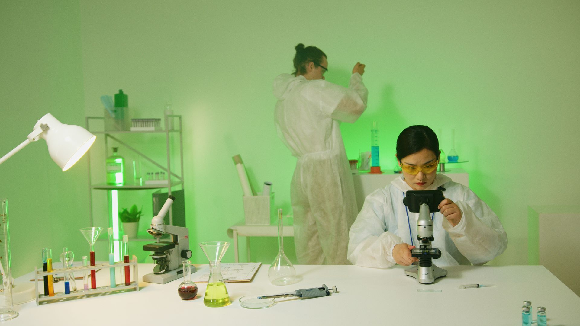A Woman using a Microscope