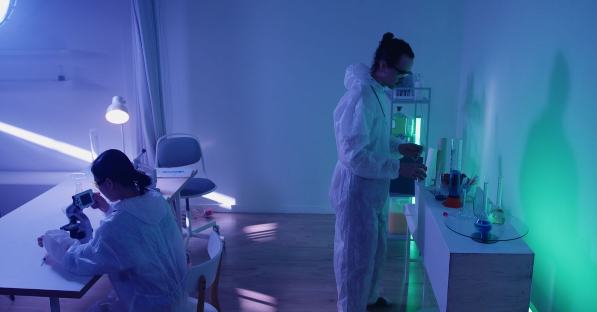 Scientist working late at night in a lab with glowing equipment