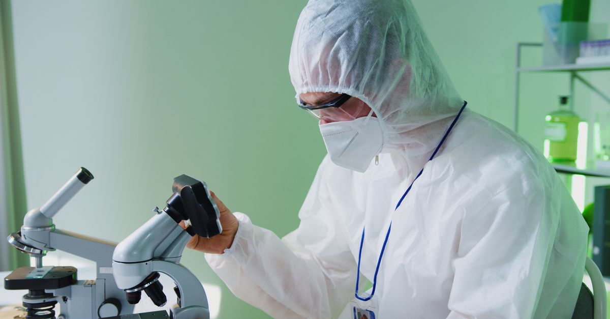 Scientist looking surprised at a petri dish with mold, vintage laboratory setting