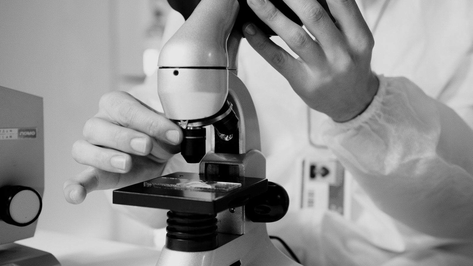 Scientist using microscope