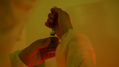 Free Close-up of a scientist handling a syringe and vial, highlighting laboratory work. Stock Photo