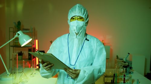 Free A scientist in full protective gear conducting research in a laboratory setting. Stock Photo