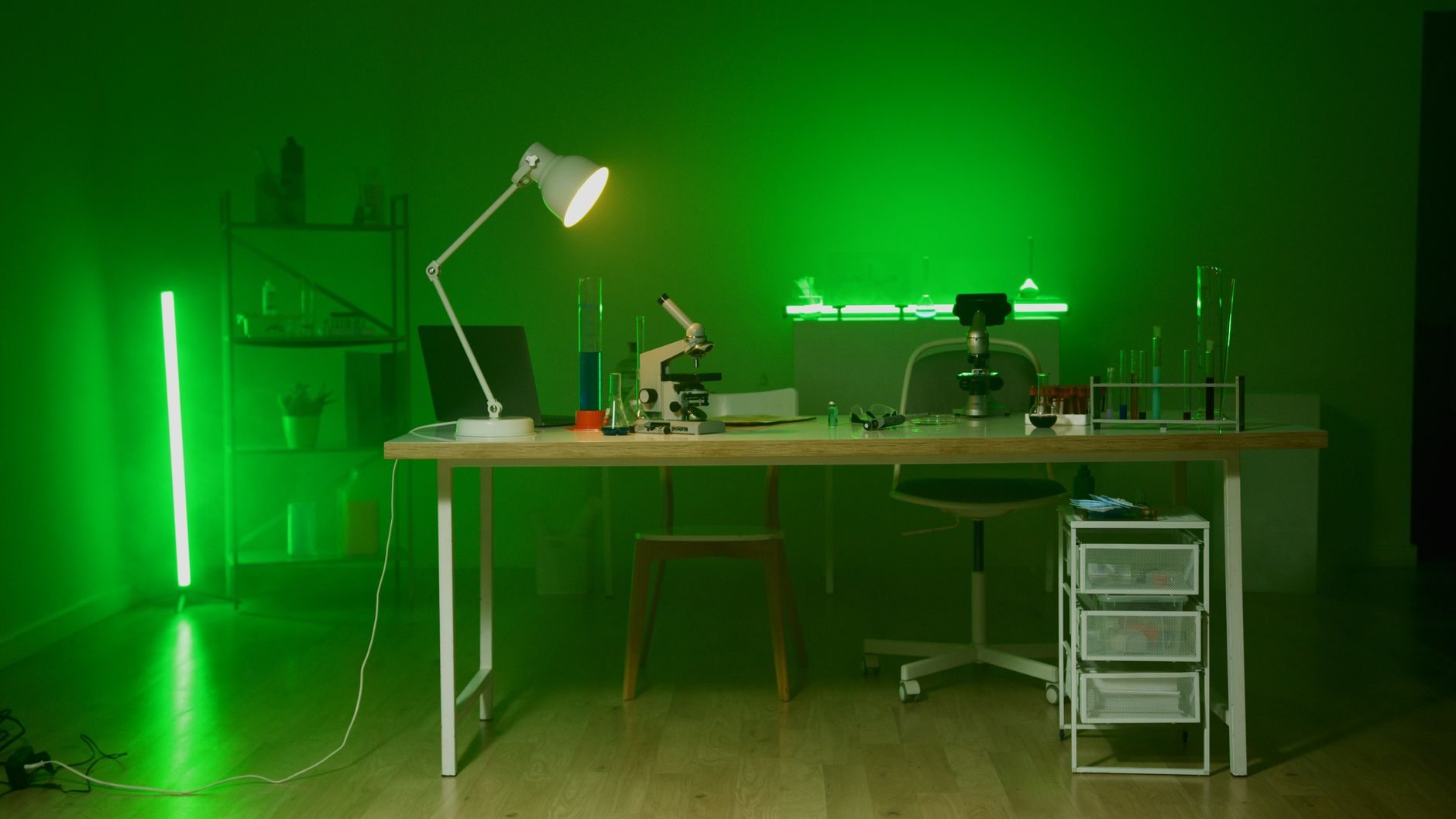 A modern lab setup with a microscope and green lighting, focused on research and technology.