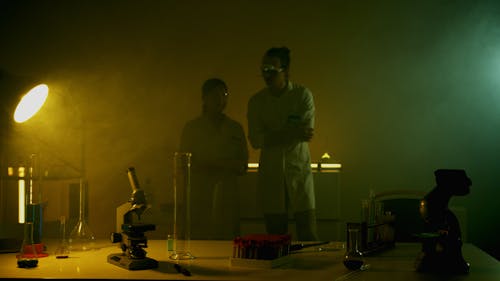 Scientists Standing in Dark Laboratory