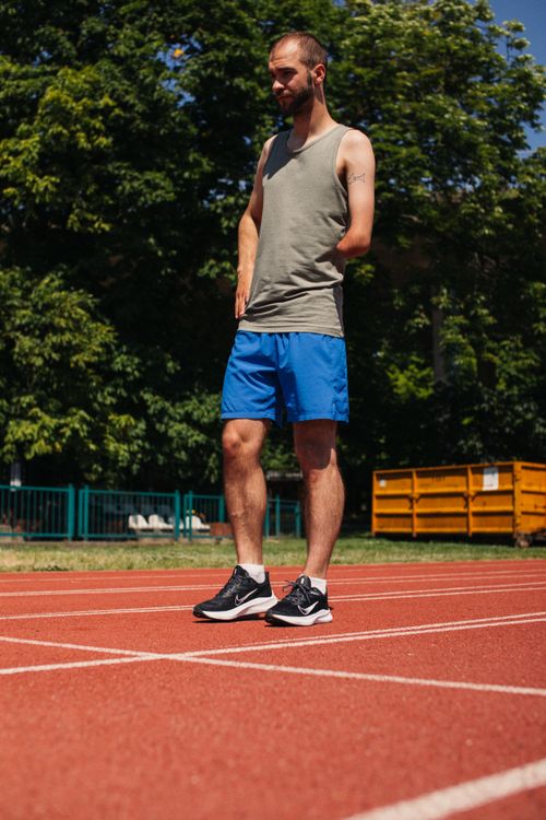 Free A determined male amputee athlete stands ready for his workout on an outdoor running track. Stock Photo