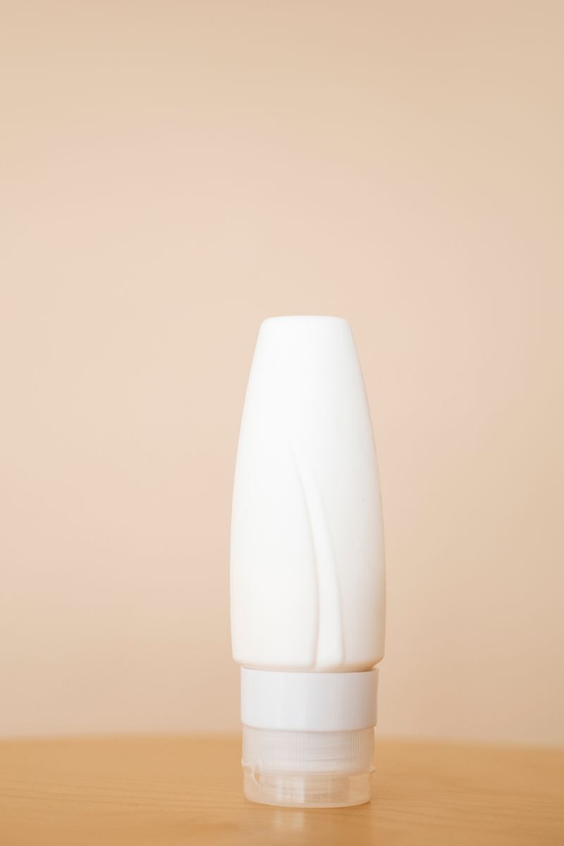 White skincare bottle on a neutral beige background